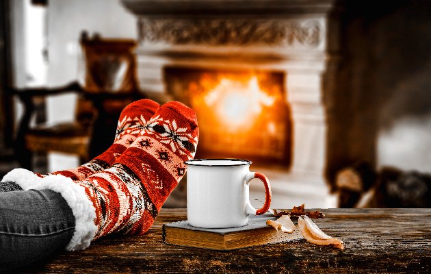 Resting and drinking hot tea in front of the fireplace.
